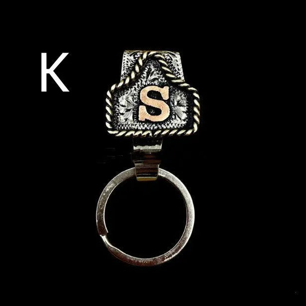 Handmade metal cow tag style key holder shown in one of its 26 colour options, attached to a keyring.