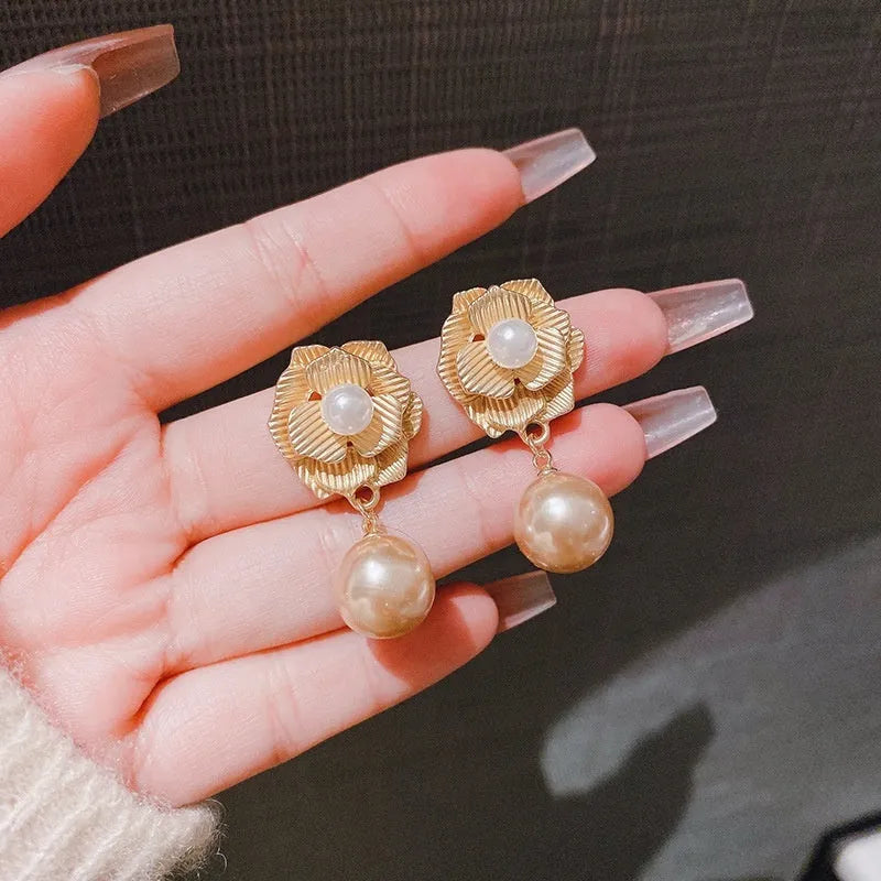 Gold-colour Hong Kong style floral stud earrings with opal stone and ice flower design on rose pearl motif.