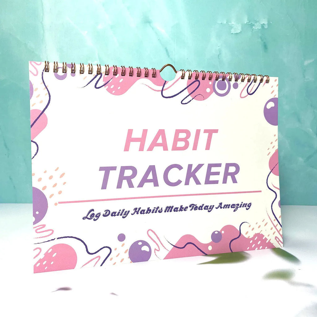 Habit tracking journal in four colour options showing 21cm × 28cm size
