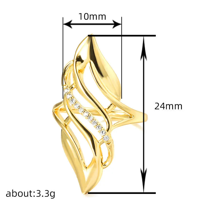 Gold tone women's ring with an exaggerated curved design on a model's finger.