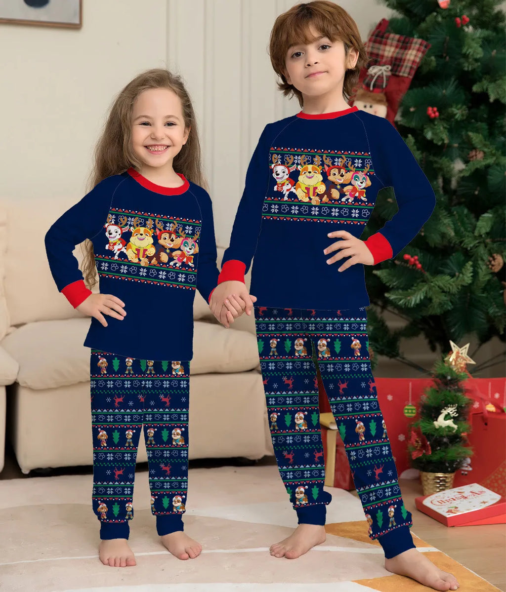 Red and black plaid Christmas pajama set with deer print, shown on matching family members including a dog.