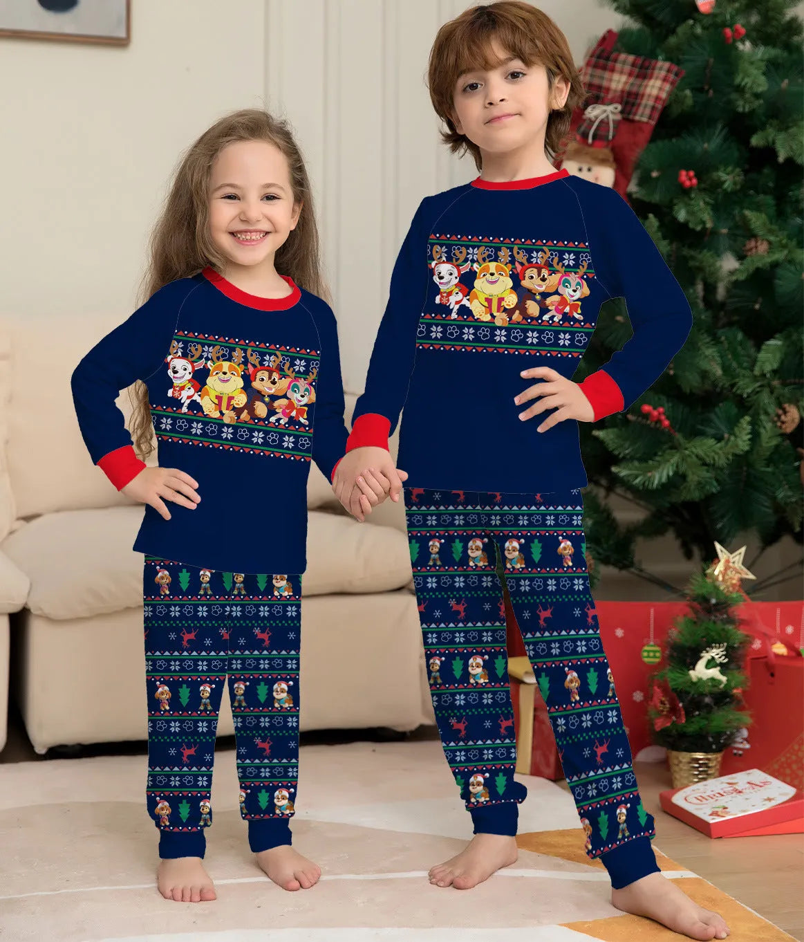 Red and black plaid Christmas pajama set with deer print, shown on matching family members including a dog.