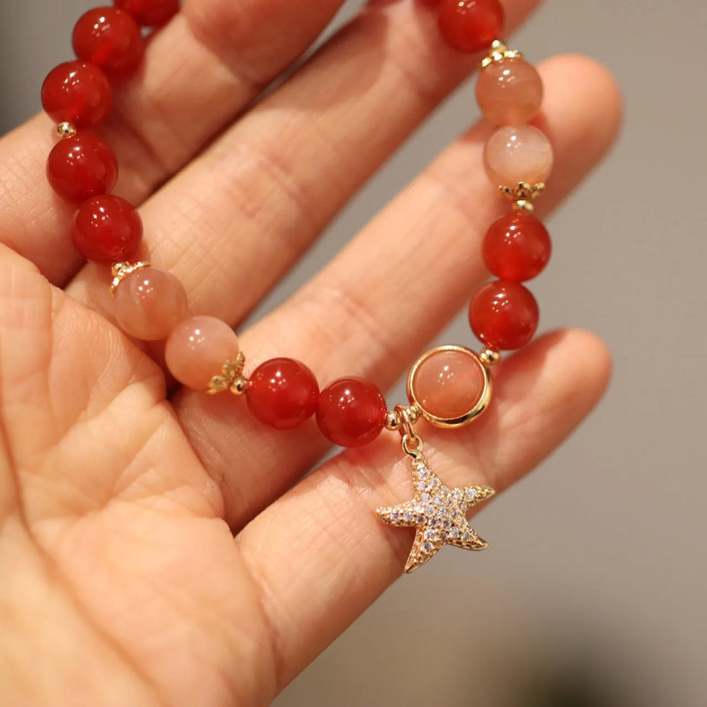 Handmade red agate and sunstone bracelet with carved xiangyun ethnic motifs, 8mm bead diameter