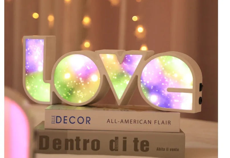 Rainbow style LED LOVE decorative table lamp with plastic shade on a table