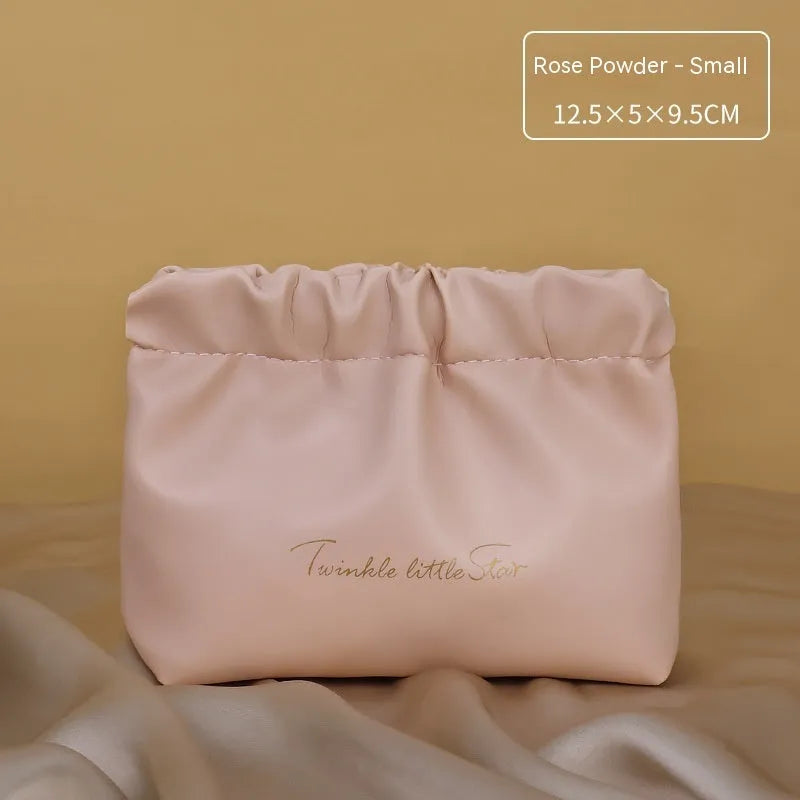 PU leather travel toiletry bag in classic black colour, showing large capacity and zipped compartments.