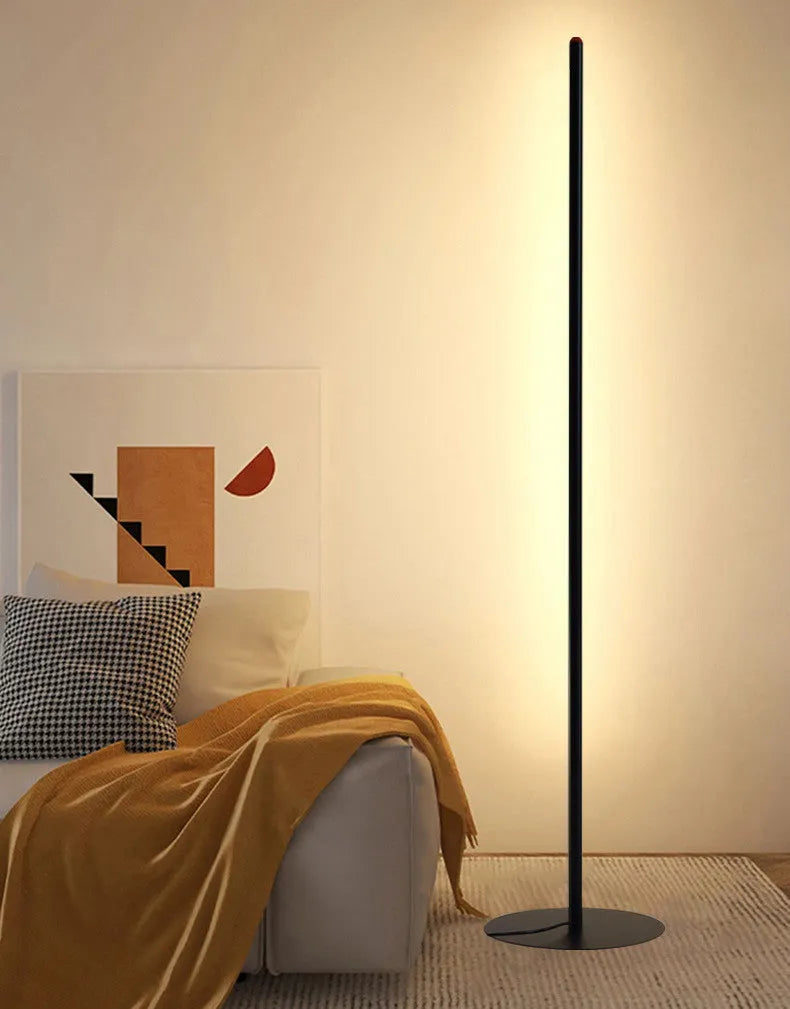 Vertical aluminium alloy floor lamp in modern simple style beside sofa