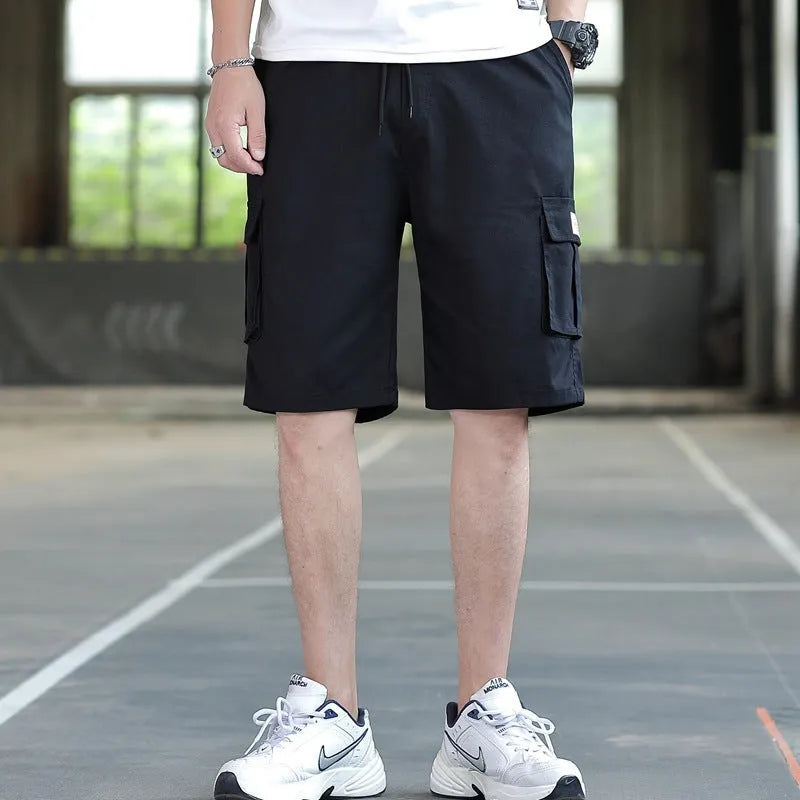 Man wearing loose-fit khaki casual trousers, showing the Korean style and thin fabric texture.