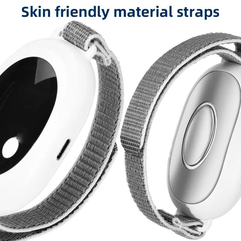 White wireless sleep aid bracelet with handheld remote control on a surface