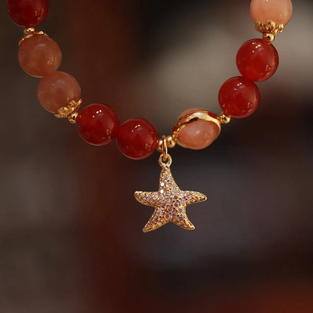 Handmade red agate and sunstone bracelet with carved xiangyun ethnic motifs, 8mm bead diameter