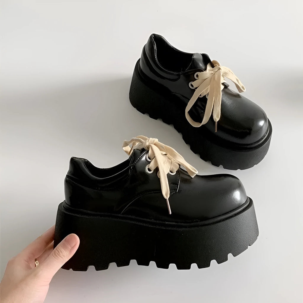 Matte black women's lace-up shoes with a chunky English muffin heel and thick rubber sole.