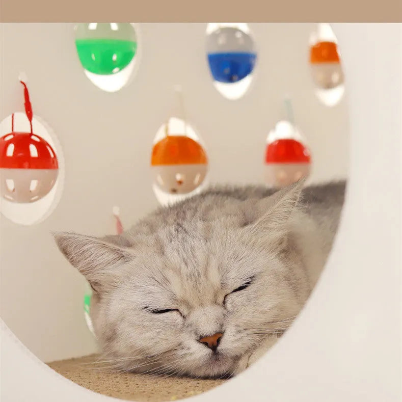 White plastic integrated cat scratch board with attached enclosed nest and curving tunnel toy for indoor cats.