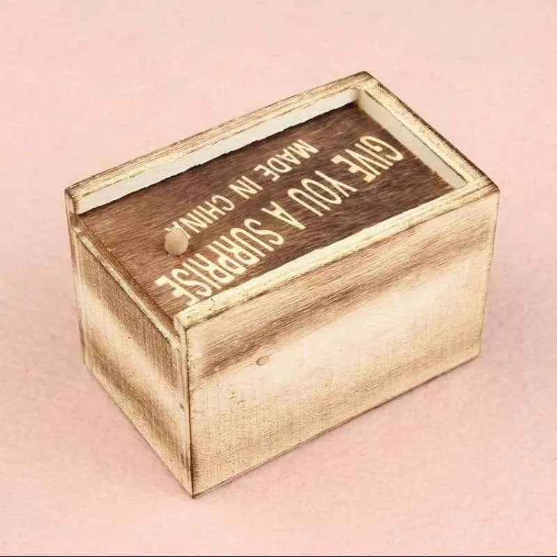 Camellia wood trick box with spider prank element on white background for scary spoof jokes
