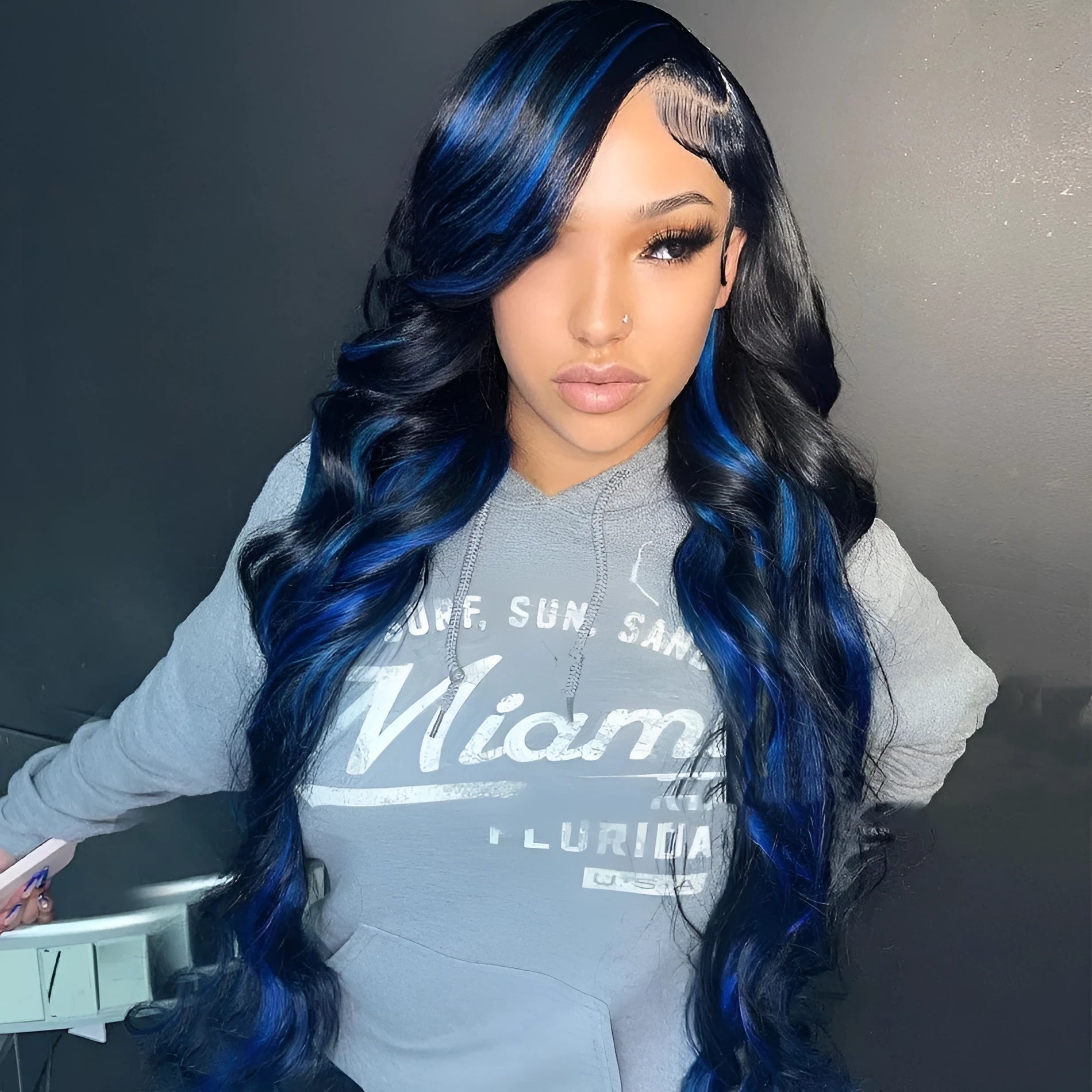 A woman wearing a real human hair lace front wig with a 4x4 lace closure, showcasing long, styled hair.