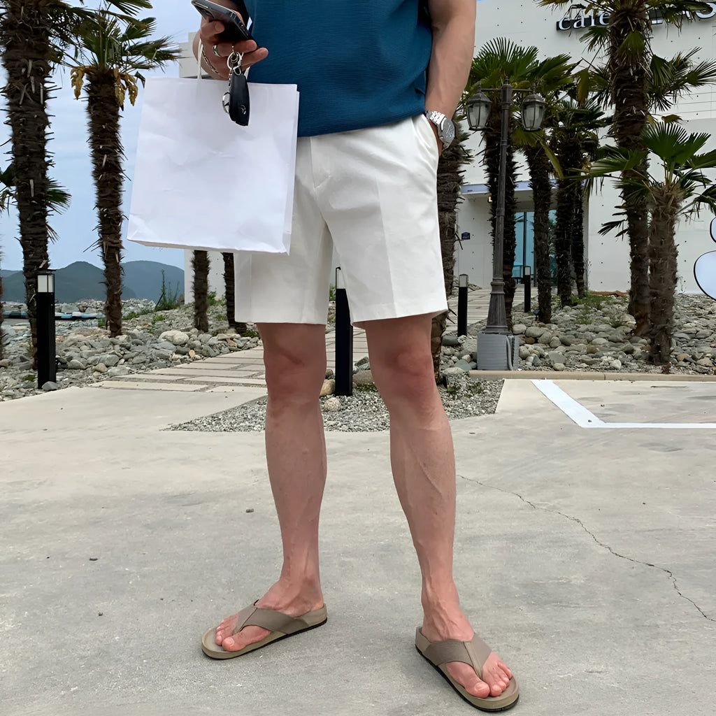 Man wearing solid colour straight-leg casual shorts in a loose fit.