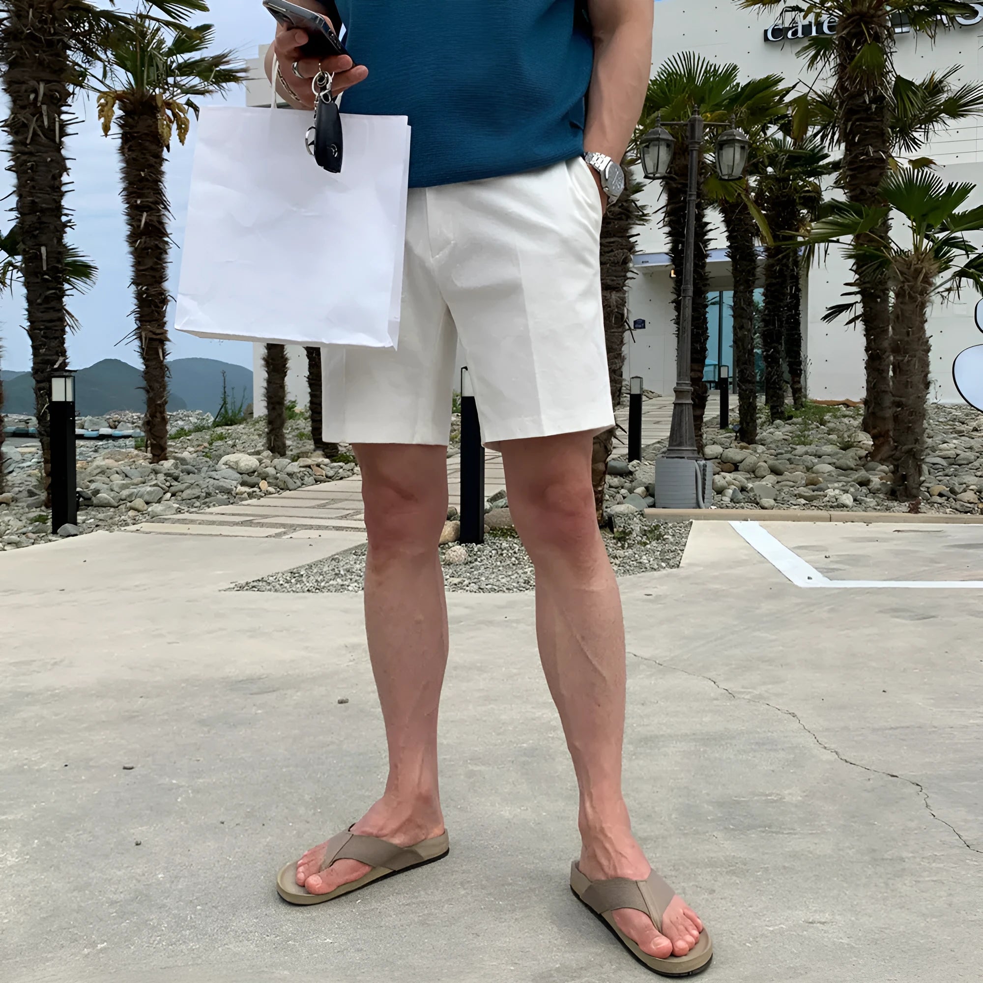 Man wearing solid colour straight-leg casual shorts in a loose fit.