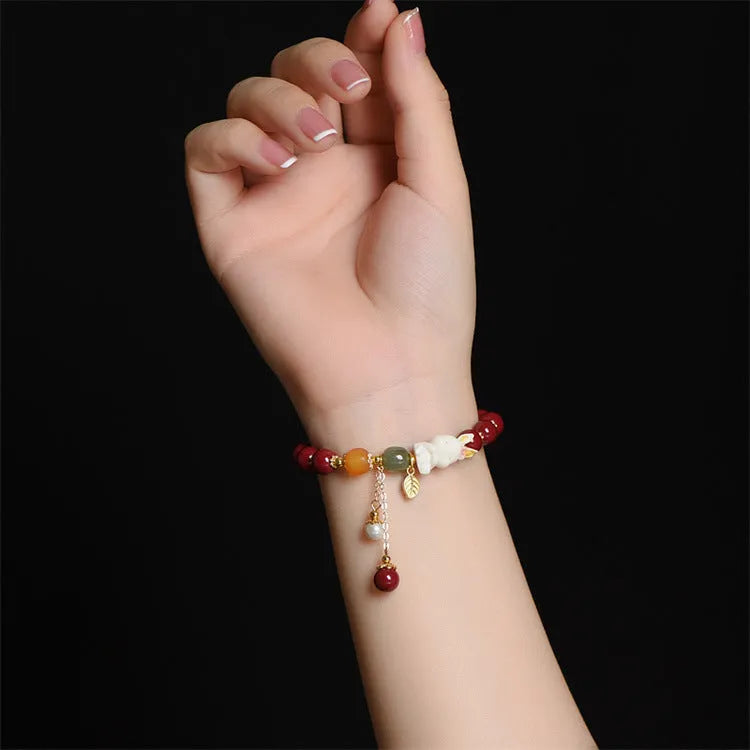 Tian Yu natural cinnabar bracelet with rabbit motif in purple gold sand colour