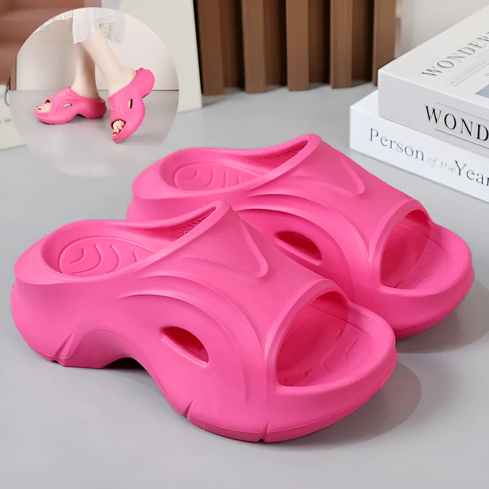 Women's thick-soled EVA slipper in rose red colour on a sandy beach background.