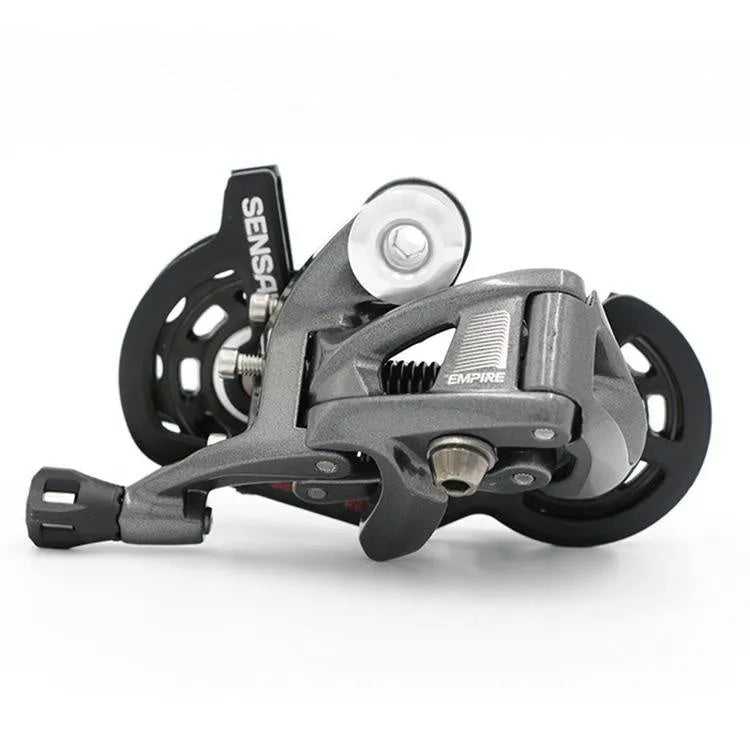 Aluminium road bike transmission kit showing hand change dial, front dial, short leg rear derailleur, chain, and decorative beads.
