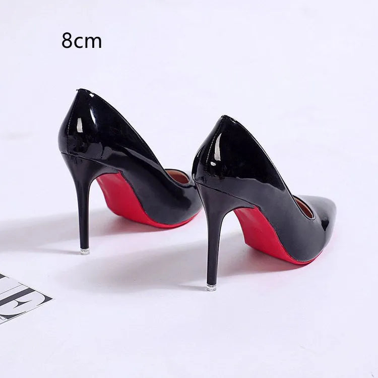 Women's black stiletto heel pump with pointed toe and shallow mouth opening on a white background.