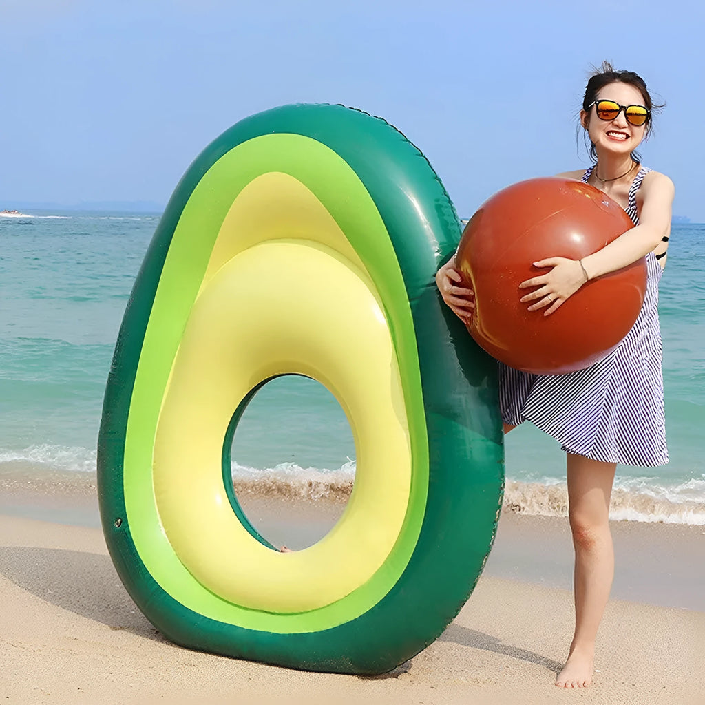 Large green inflatable avocado pool float on blue water.