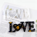 Flexible silicone epoxy mould showing raised letters for words love, home, family, live, hello, blessed.