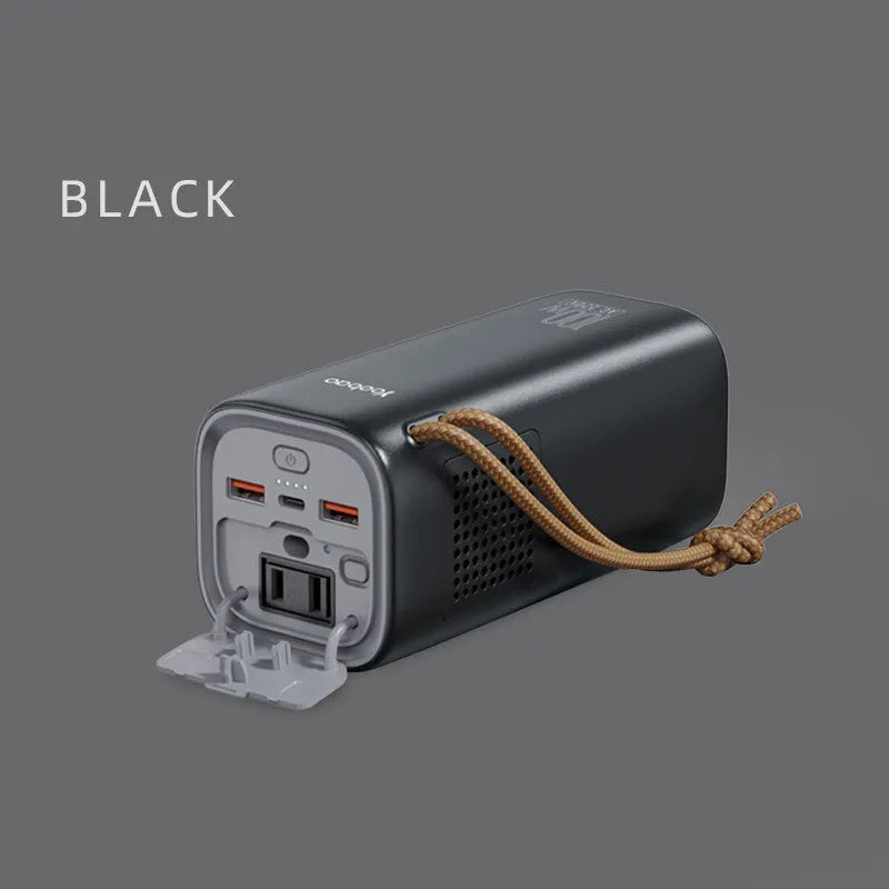 Black portable power bank with solar panel, showing USB ports and car charging socket