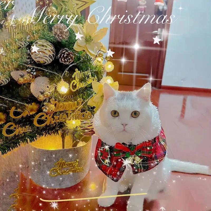 A red festive pet scarf with a bell pattern fastened around a dog's neck with an elastic collar.