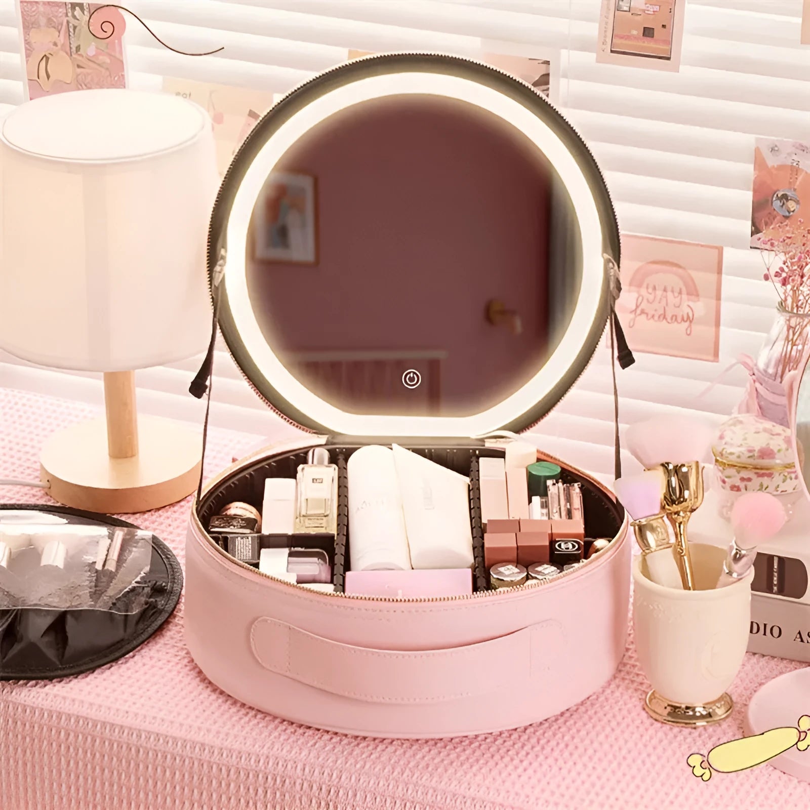 Round smart LED makeup bag with integrated mirror lights in cherry blossom pink colour with lattice partitions visible