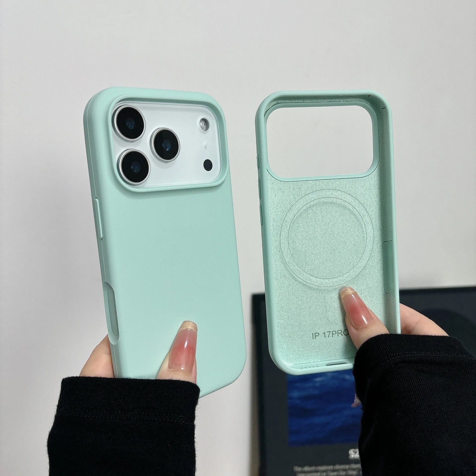 Liquid silicone magnetic iPhone case with Ai button in antique white colour on a table.