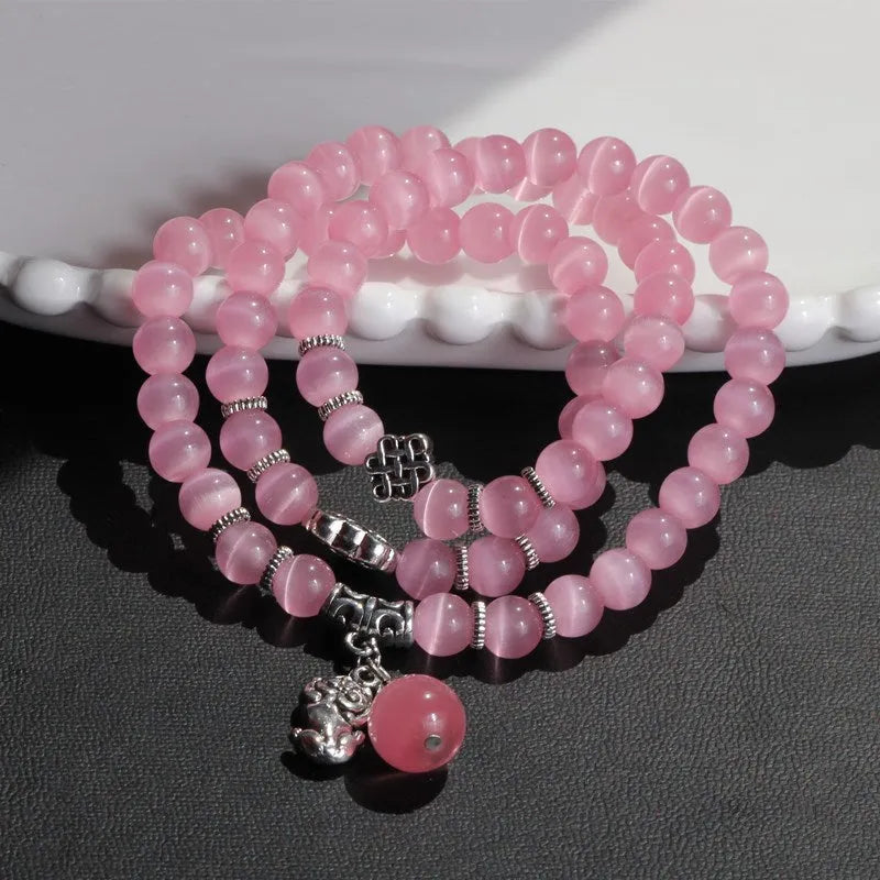 Opal crystal cat eye bracelet with lucky cat charm, shown in one of six colour options.