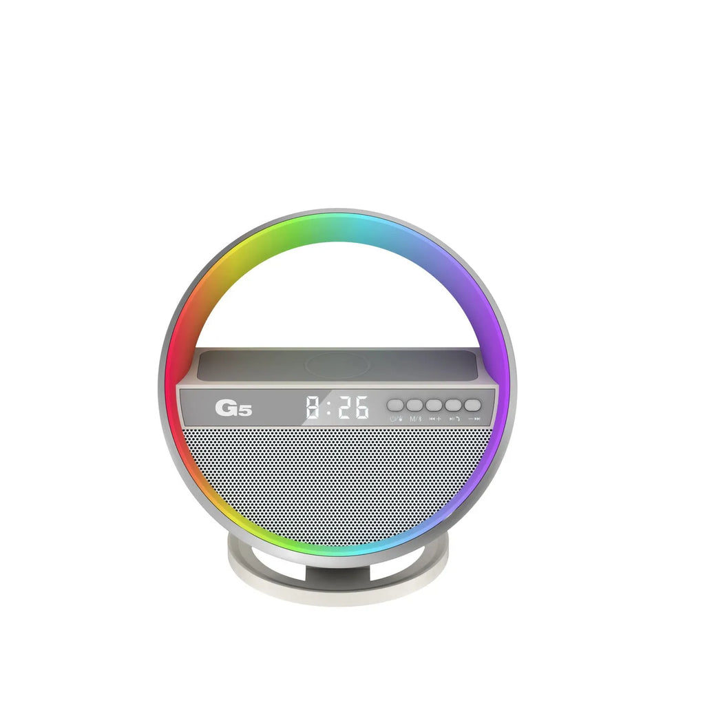 White multifunction RGB night light wireless charger and Bluetooth speaker on a desk with a smartphone on the charging pad
