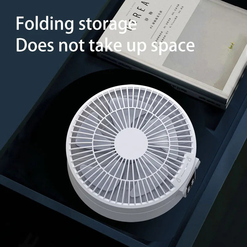 White portable folding fan with remote control on desk showing night light and adjustable angle
