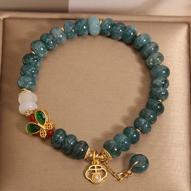 Blue water jade abacus bead and white agate bracelet with alloy and rhinestone details for women.