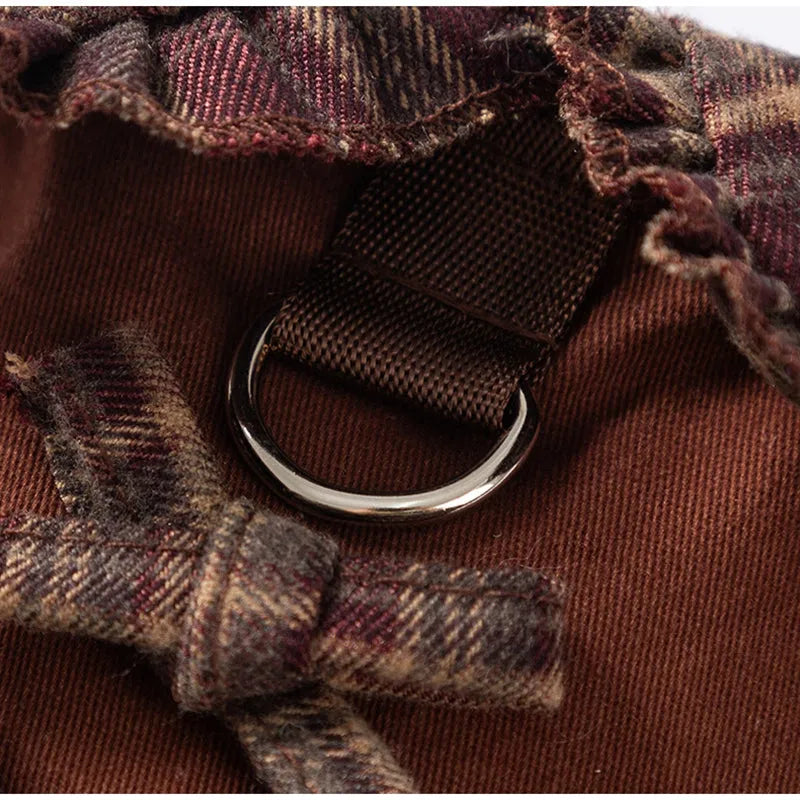 Fleece-lined brown plaid pet sweater dress with ruffle trim on a small dog, showing stretchable knit and skirt silhouette