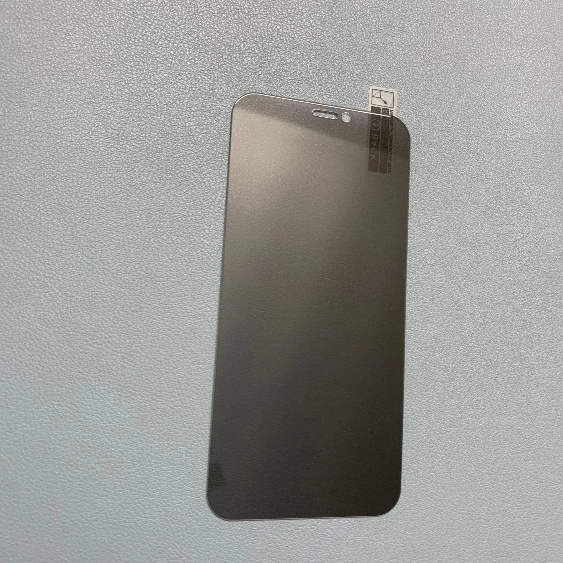 iPhone anti-peeping tempered glass screen protector showing privacy filter effect from side angle.