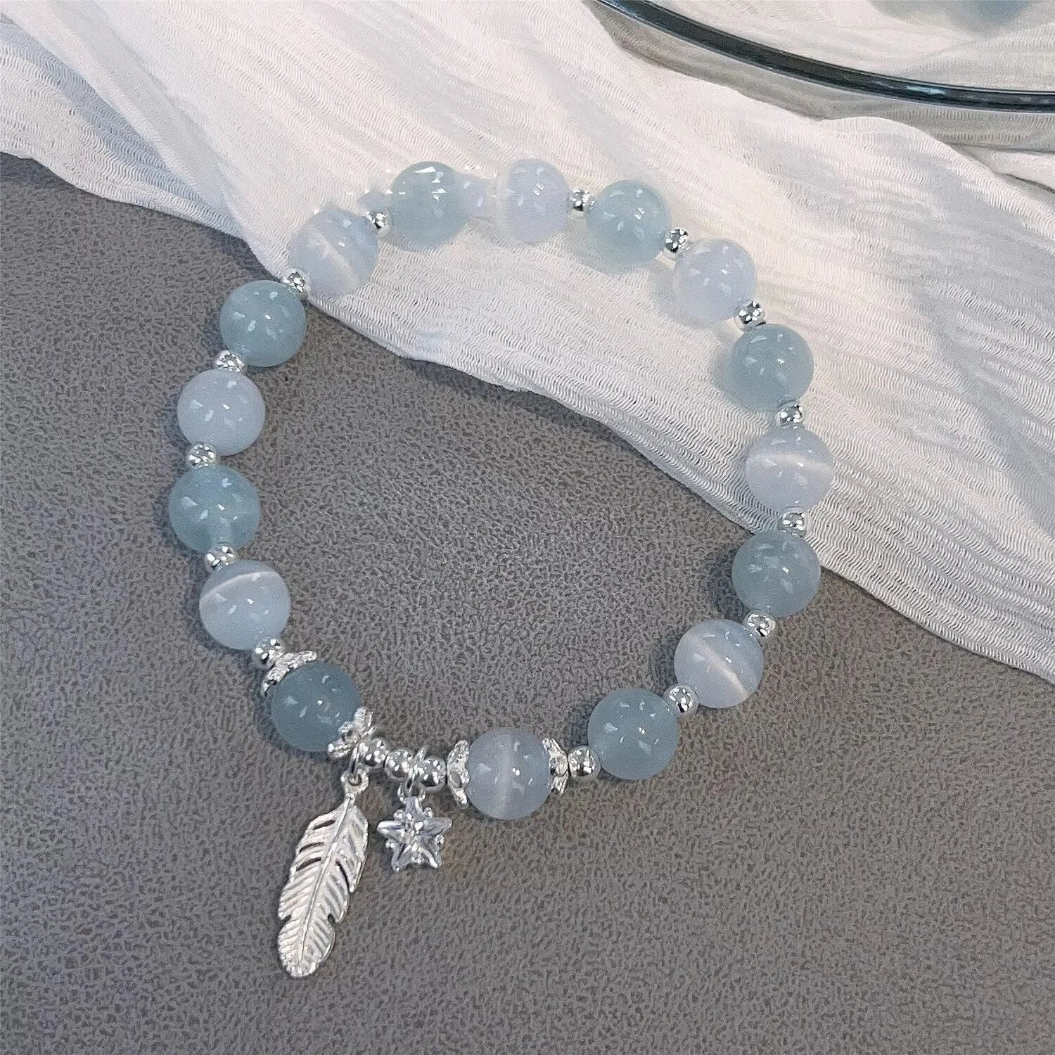 Small white crystal bracelet with eight star design in blue moonlight colour