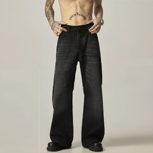 Black loose straight retro jeans with zipper fly closure on plain background