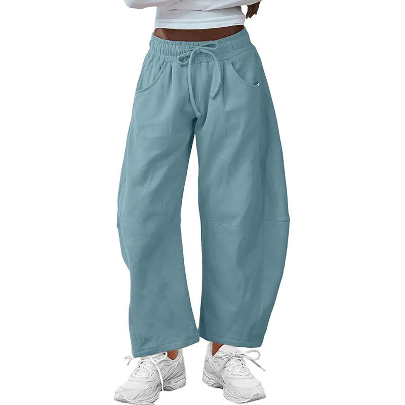 Loose cropped sweatpants with drawstring waist and side pockets in street fashion styling