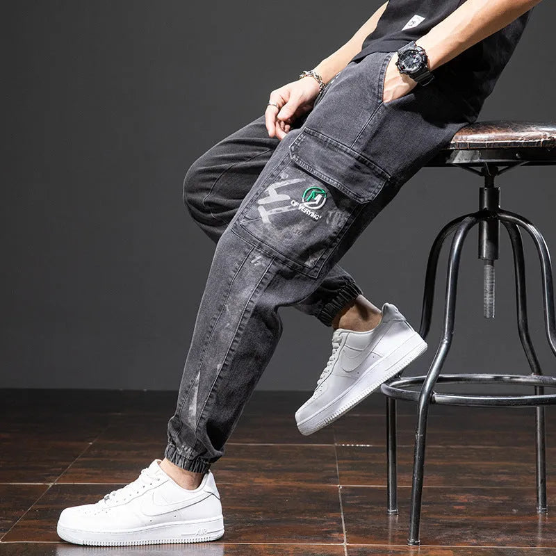 Men's loose straight-leg cargo casual jeans in blue, showing cargo pockets and mid-waist fit.