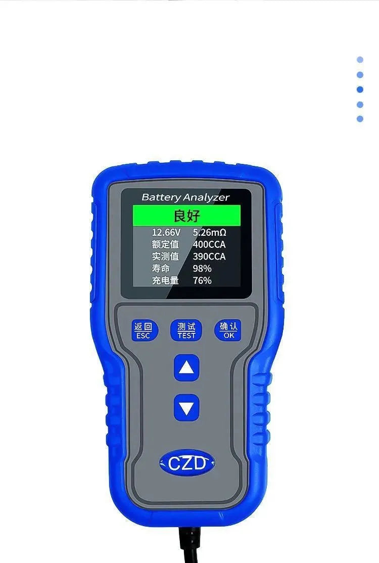 TKM016 car battery tester on a workbench, showing its compact 167x86x32mm size and handheld design