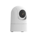 White indoor pan-tilt security camera with wide-angle lens on a desk.