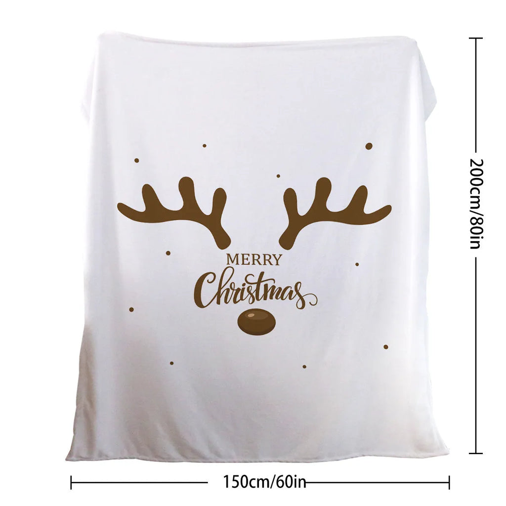 White flannel velvet deer antler pattern Christmas blanket on a sofa
