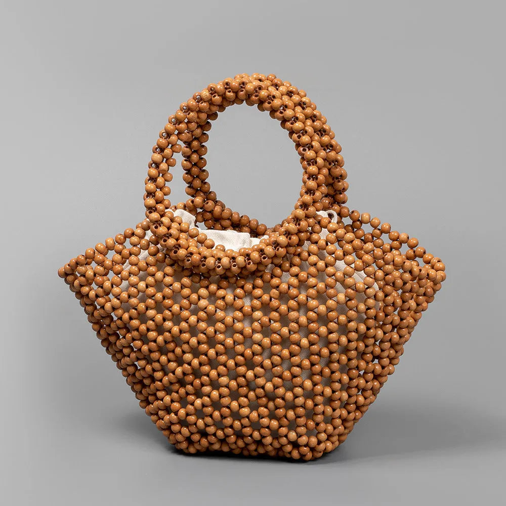 Hand-woven dumpling-shaped handbag with wooden beads in milky white colour