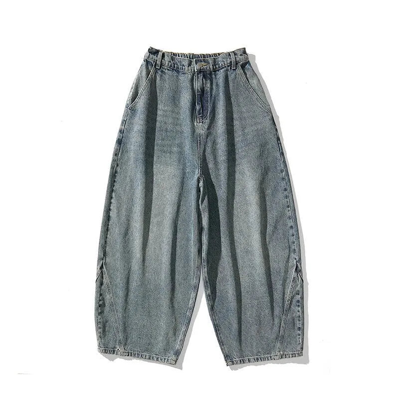 Men's plus-size light blue wide-leg baggy denim jeans on a hanger.