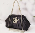 Women's black polyester messenger bag with chain detail, diamond patterns, and document organiser compartment