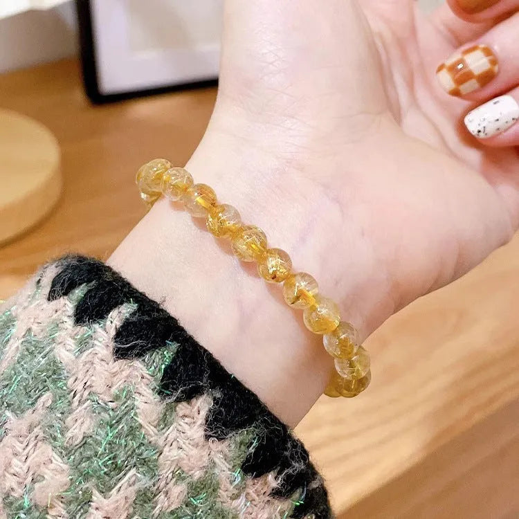 Women's gold rutilated quartz sunstone crystal bracelet with diamond beads