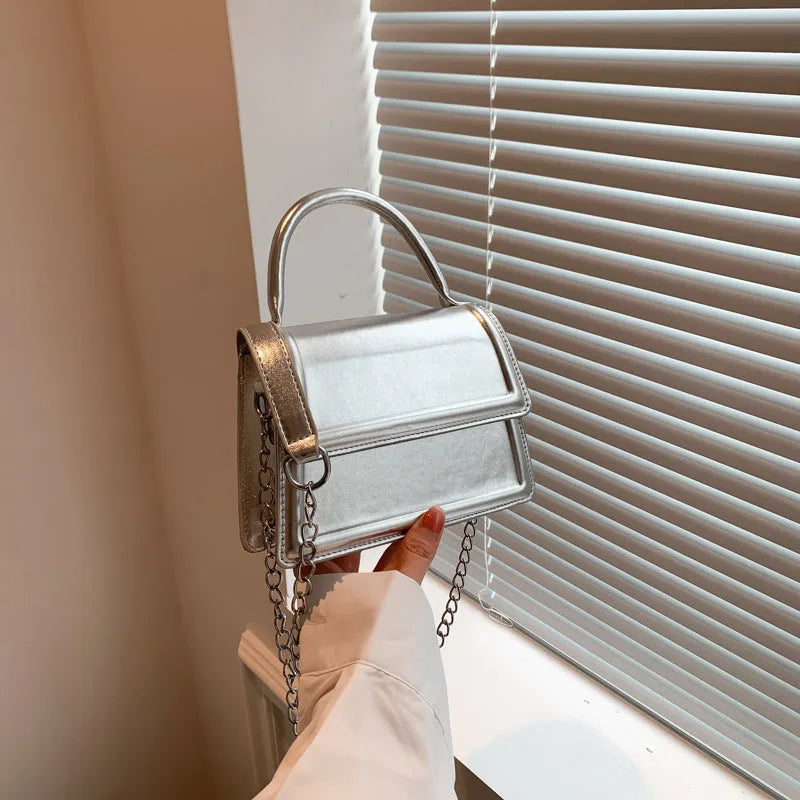 Retro square crossbody bag in PU leather with sewing line details, shown in a selection of colours.