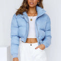 Loose fit blue women's polyester jacket with long sleeves on a hanger