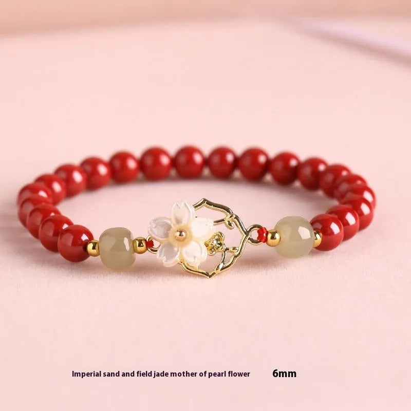 Cinnabar bracelet with Hetian Jade lotus charm and Bells of Ireland accents in New Chinese style