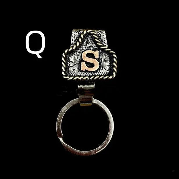 Handmade metal cow tag style key holder shown in one of its 26 colour options, attached to a keyring.